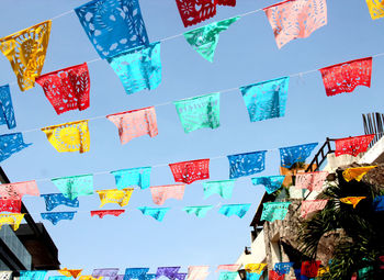 Low angle view of colorful decoration hanging against clear sky