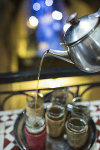 Close-up of tea being poured in cups in restaurant