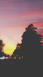 Silhouette of trees against sky at sunset