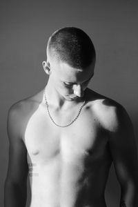 Young man looking away against white background