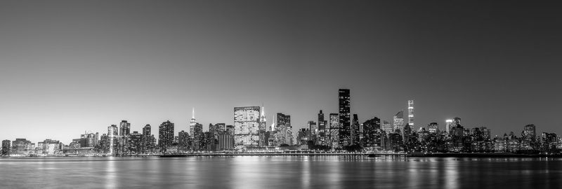 Scenic view of river and buildings against sky