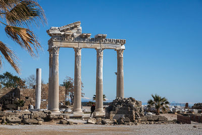 Low angle view of historical building against clear blue sky