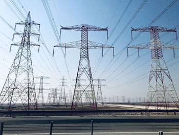 Low angle view of electricity pylon against sky