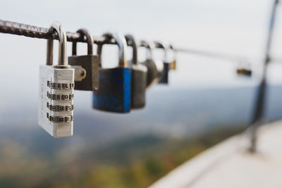 Close-up of padlocks hanging on railing