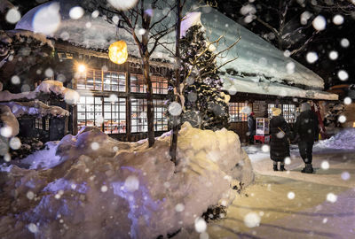 People in market during winter at night