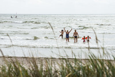 Family bathing in sea