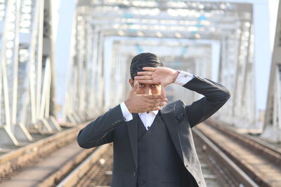 Man standing on railroad track