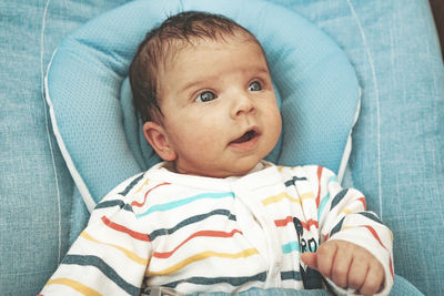 Cute baby girl on bed at home