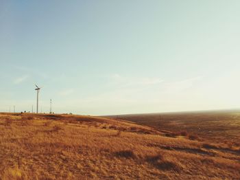 View of windmill on field against sky