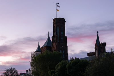 Low angle view of building against cloudy sky