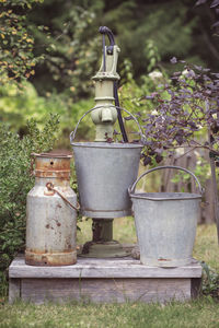 Empty containers at hand water pump