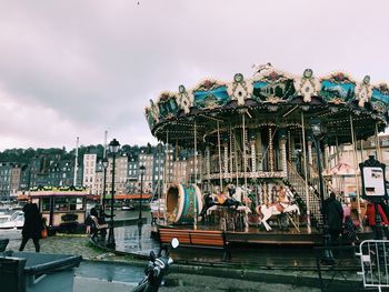 Group of people in amusement park against sky