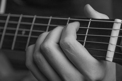 Cropped image of person playing guitar