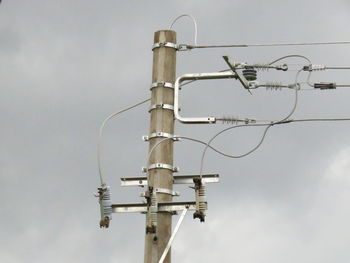 Low angle view of power lines against sky