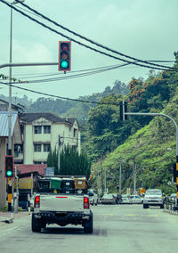 Cars on road against buildings