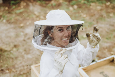 A portrait of a woman beekeeper