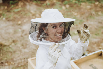 Portrait of woman holding white hat