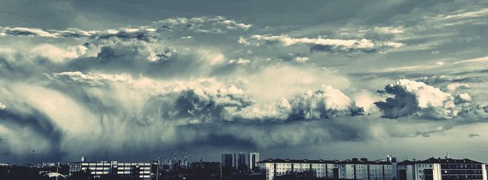 Panoramic view of buildings in city against sky