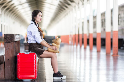 Portrait of young woman standing in city