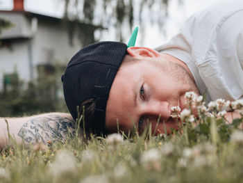 Bearded guy lying in a clearing of flowers