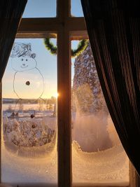 Scenic view of sunset seen through glass window