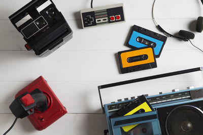 Directly above shot of boom box and audio cassettes on table