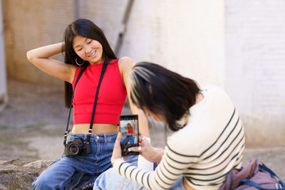 Side view of young woman standing at home