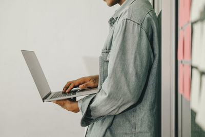 Side view of man using mobile phone