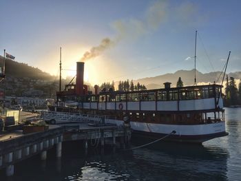 Boats at harbor during sunset