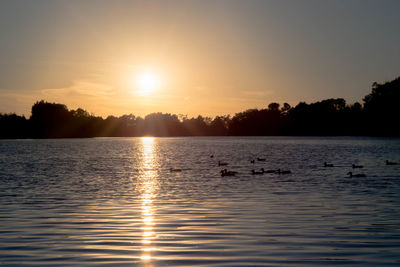 Scenic view of lake against sky during sunset