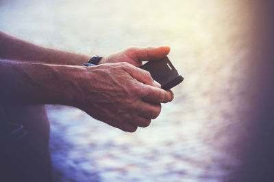 Cropped image of hands using mobile phone