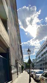 Street amidst buildings in city against sky