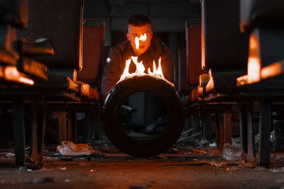 Close-up of burning tire against man in background in train