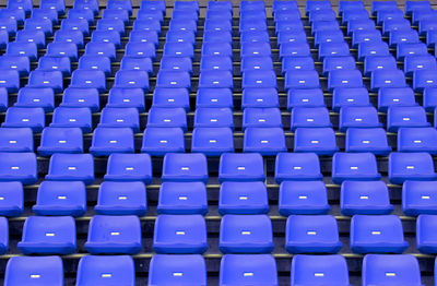 Full frame shot of empty blue seats at stadium