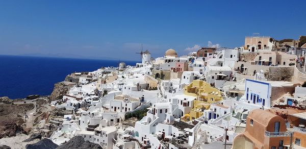 High angle view of townscape by sea against sky