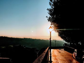 Scenic view of silhouette trees against clear sky during sunset