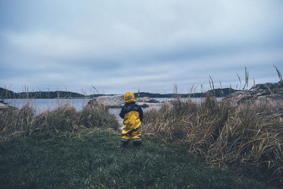 Child standing at sea