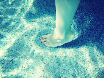 Low section of woman in swimming pool