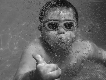 Close-up portrait of boy in swimming pool