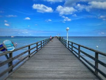 Pier over sea against sky