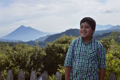 Portrait of smiling man standing on mountain