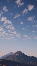 Scenic view of mountains against cloudy sky