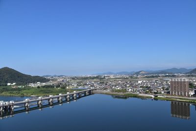 View of cityscape against clear blue sky