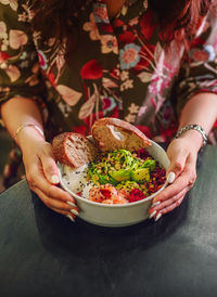 Midsection of woman holding ice cream