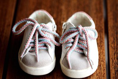 Close-up of shoes on wooden table