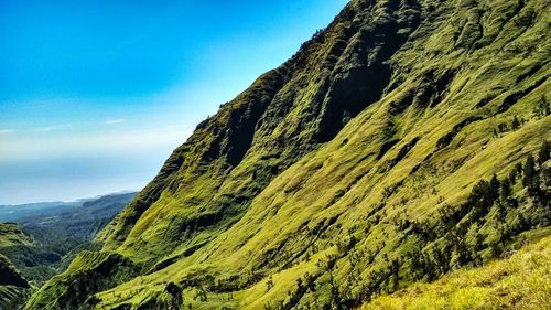 Low angle view of mountain against blue sky