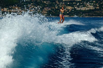 Woman wakeboarding in sea