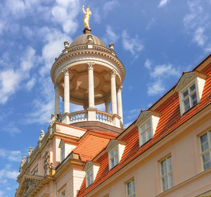 Low angle view of building against cloudy sky