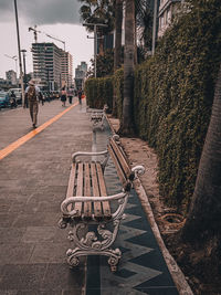 Benches on sidewalk in city