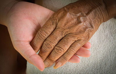 Close-up of woman hand on wall